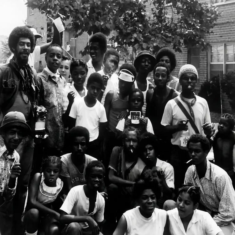 Damaged snapshot of a large group of young people, restored