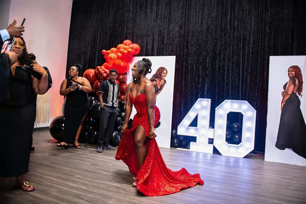 Guest of honor in a red gown at a 40th birthday celebration