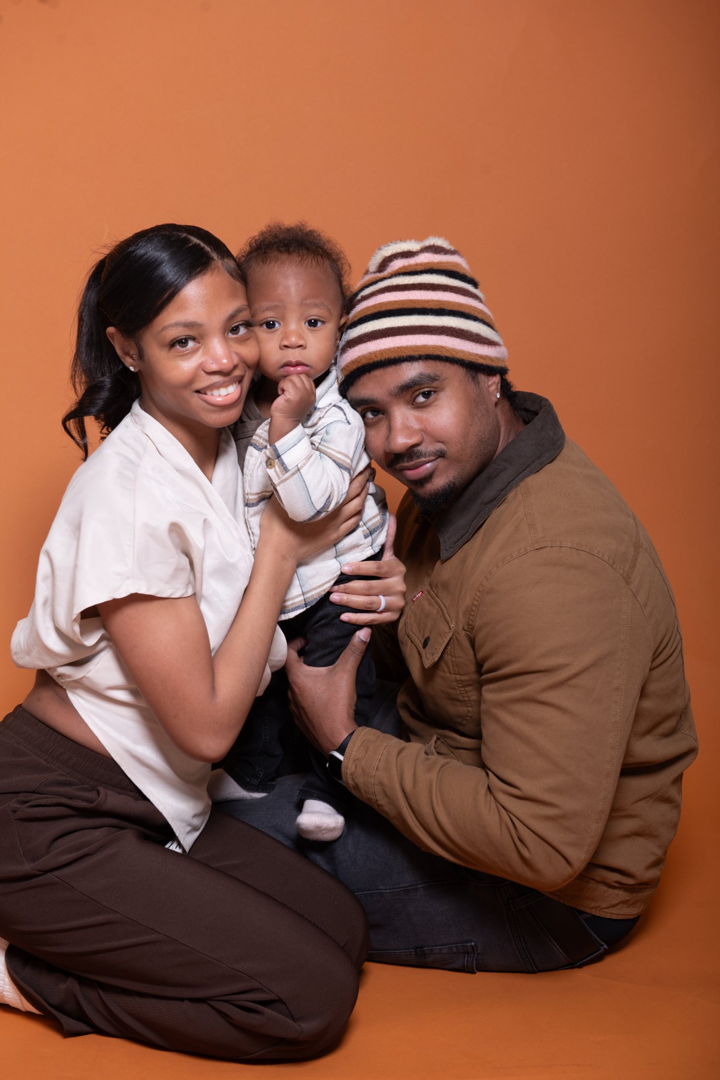 Family portrait against an orange backdrop
