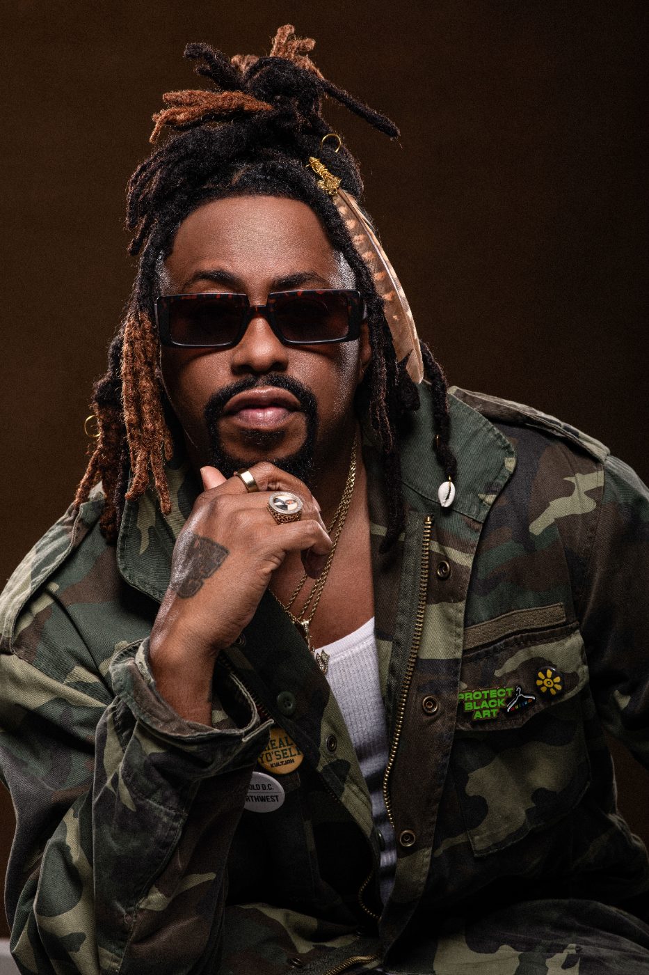 Raheem DeVaughn in a camo jacket, studio portrait