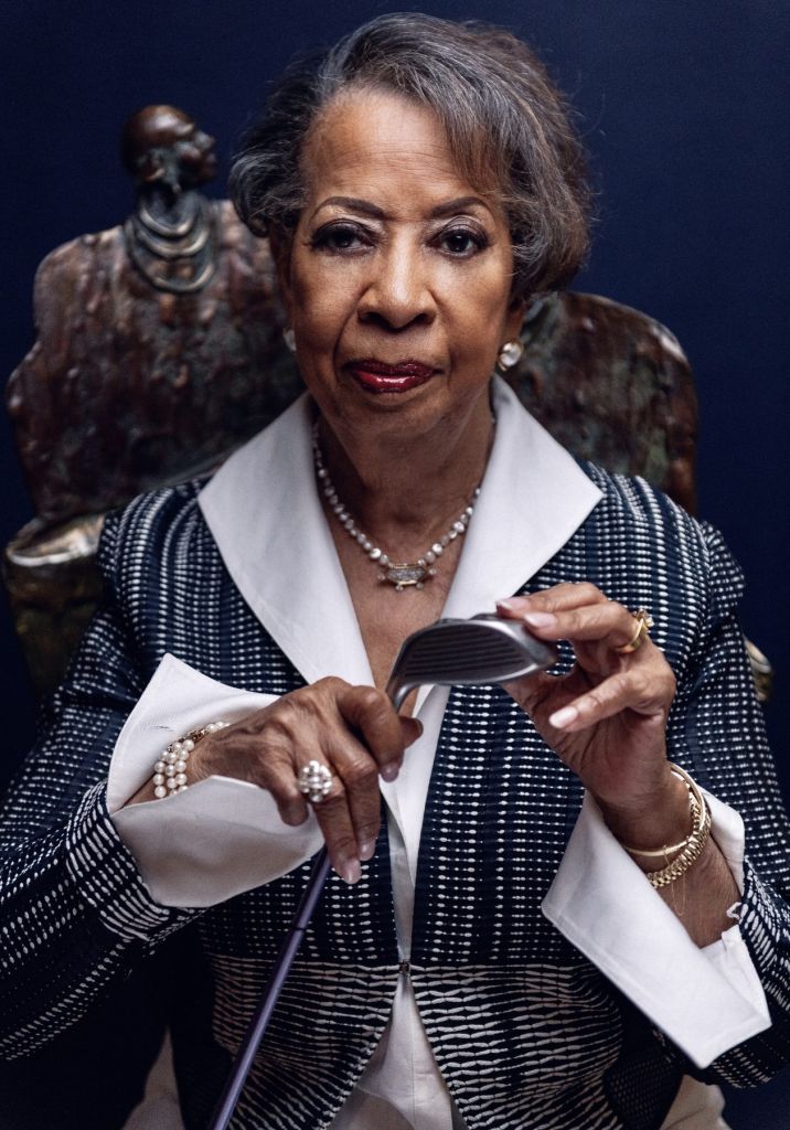 Rose Harper holding a golf ball, seated portrait