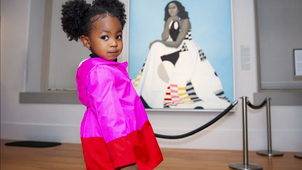 Parker Curry beside a portrait