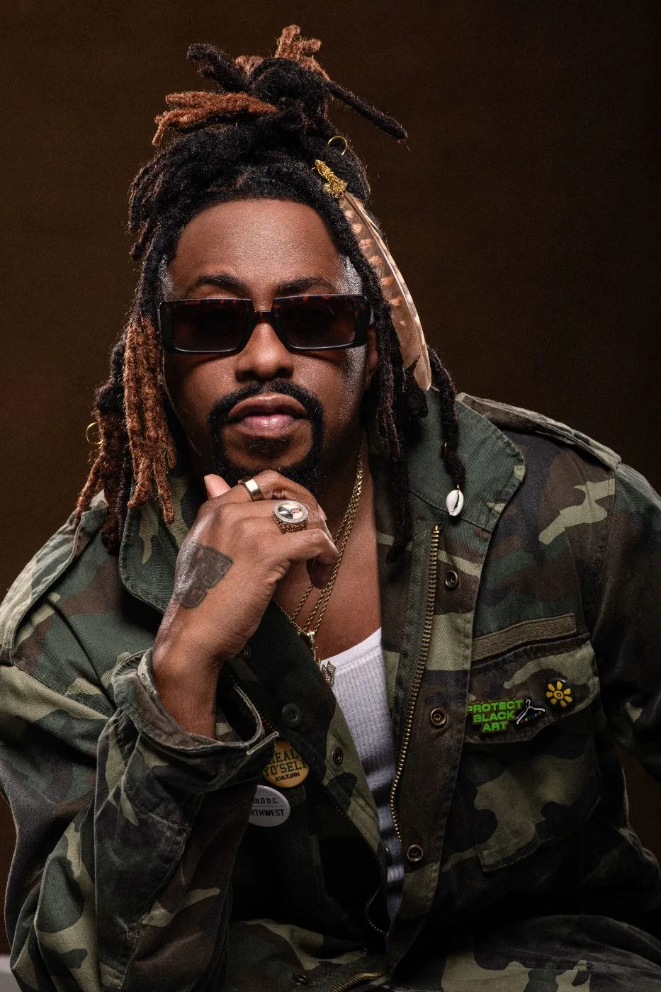 Raheem DeVaughn in a camo jacket, studio portrait